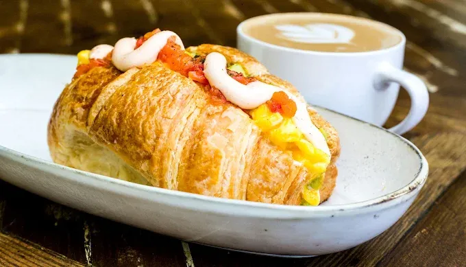 Breakfast croissant with a cup of coffee at Meraki Coffee House