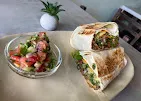 Meraki wrap and side salad served on a plate